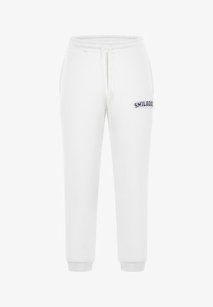 Bílé tepláky vyrobené z bavlněné směsi, s pasem na šňůrku, žebrovanými manžetami a vyšitým logem "SMILODON" na levém stehně.