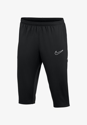 Shorts de sport noirs mi-genou avec ceinture élastique et logo Nike Swoosh blanc sur la cuisse droite.