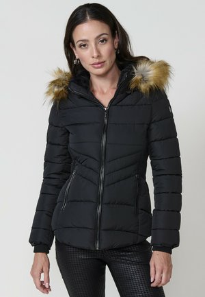 Chaqueta de plumas negra con diseño acolchado horizontal, cierre de cremallera en la parte delantera, dos bolsillos laterales y un borde de piel sintética desmontable en la capucha.