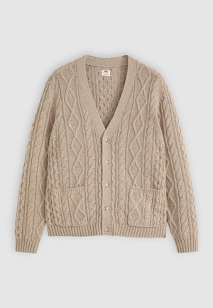Beige cable knit cardigan with V-neck, button front, two front pockets, and ribbed cuffs and hem on plain background.