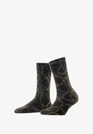 Chaussettes noires ornées d'un motif de chaîne dorée texturé, fabriquées dans un matériau doux, avec une hauteur standard et des zones de bout et de talon renforcées.