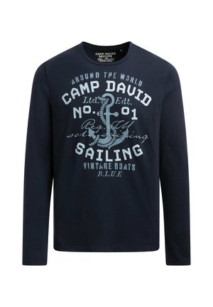 Navy long-sleeve shirt featuring front graphics of an anchor and text. Cotton material with a round neckline and printed design.