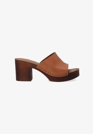 Brown leather slide sandal with a rounded open-toe, block heel, and stitching detail along the upper. Platform sole for added height.