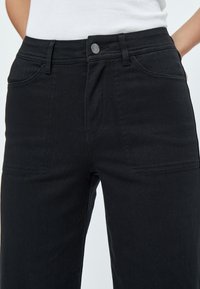 Desires DEFLORENCE PANTS - Bootcut-farkut - black