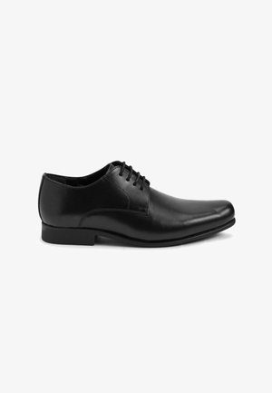 Black leather dress shoe featuring a smooth surface, rounded toe, and five eyelet lace closure. Subtle stitching accents around the upper.
