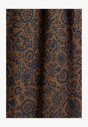 Brown fabric with intricate dark blue floral and paisley patterns, showing a soft, textured surface with gentle folds.