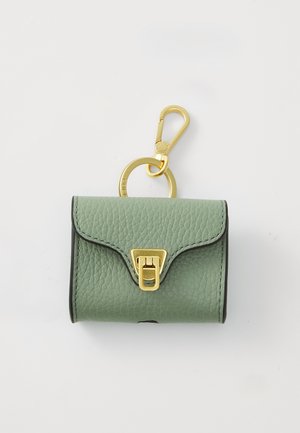 Green textured leather mini bag with a gold clasp and metal keyring. Features curved flap closure and black edging detail.