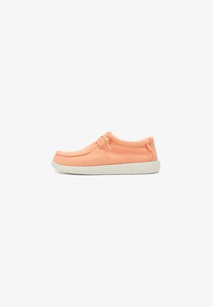 Orange canvas shoe with a rounded toe, elastic laces, and a textured white rubber sole. Smooth surface with minimal stitching details.