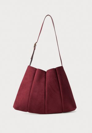 Burgundy suede handbag with a pleated design, a long leather strap, and a structured shape. Smooth texture with a matte finish.