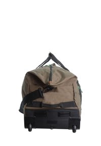 Rolling duffel bag in olive green, made of durable fabric, features a top zipper, side handle, and black plastic base with wheels.