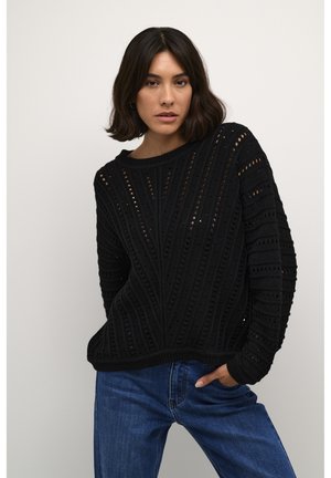 Black knitted sweater featuring a textured pattern and openwork design, with a crew neckline and long sleeves. Paired with blue denim.