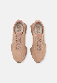 Lyserøde sneakers med en kombination af ruskind og mesh overdel, med en polstret krave, snørebåndsdesign og gummisål.