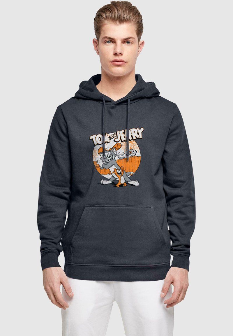 Sötét szürke kapucnis pulóver, Tom és Jerry grafikával. Pamutkeverék anyag, kenguruzseb, bordázott mandzsetta és szegély részlet.