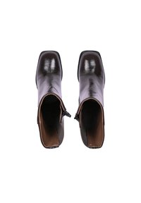 Bottes de cheville en cuir marron avec une finition brillante, bout carré et fermeture éclair sur le côté. Intérieur doublé de matériau beige. Semelles plates.