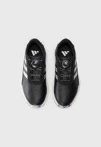 Black athletic shoes featuring a textured upper, white three-stripe design, and a central Boa lacing system on a white sole.
