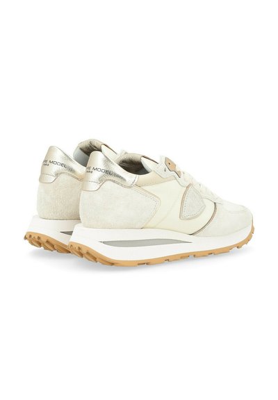 Cream suede and leather sneakers featuring metallic accents, textured overlays, and a rubber sole with a contrasting gum outsole.