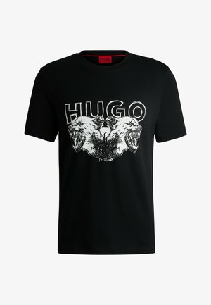 Black cotton t-shirt featuring a graphic print of a lion's face, with "HUGO" text above in white. Round neck and short sleeves.
