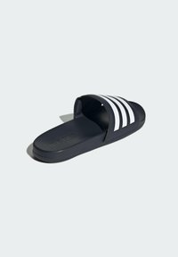 Black slide sandal with three white stripes across the upper. Features a textured sole and a soft strap for comfortable fit.