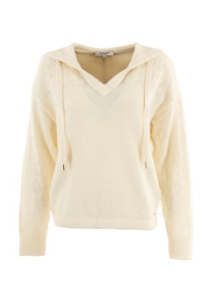 Sudadera de punto suave color crema, con cuello en V y un patrón de diamante en las mangas. Presenta cordones y un ajuste ligeramente relajado.