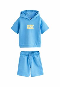 Modrá bavlněná mikina s krátkým rukávem, na předn�í straně s textem "HAPPY SMILE" v žluté barvě, doplněná o modré šortky s elastickým pasem.