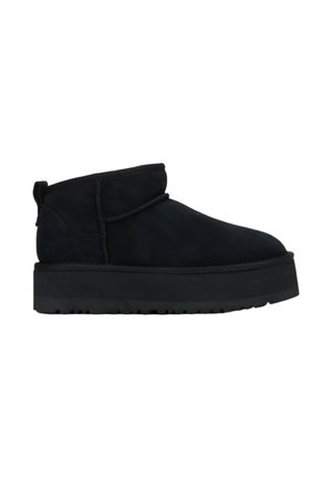 Black suede ankle boots with a rounded toe, low cuff, and textured rubber platform sole. Features minimal stitching and a pull tab.