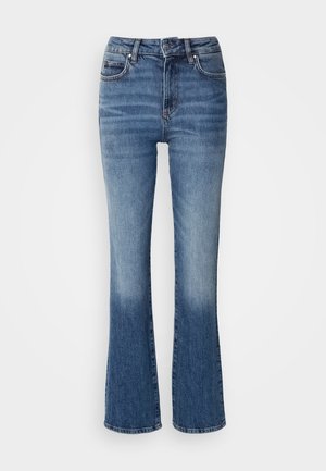 Denim flared jeans i lys til mørk blå gradient, med høy midje, fem lommer og lys falming på nederste del av bena.