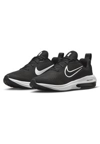 Schwarze Sportschuhe mit einem Obermaterial aus Mesh, weißem Nike-Logo und kontrastierender weißer Zwischensohle. Verfügt über einen gepolsterten Schaftrand und eine strukturierte Außensohle.