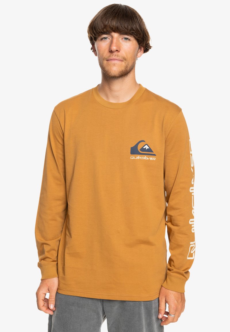 Long-sleeve shirt in mustard yellow cotton, featuring a blue logo on the chest and white text along the left sleeve for branding.
