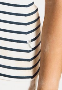 Striped top in soft, stretchy fabric with navy and cream horizontal stripes. Features a small Joules label on the side.