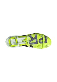 Cleated soccer shoe outsole in black and neon yellow, featuring a textured pattern and large purple branding. Transparent studs enhance grip.