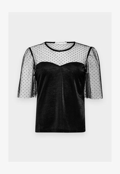 Black top with a semi-sheer black polka dot mesh overlay, short puff sleeves, and a sweetheart neckline in a smooth fabric.