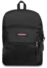 Sac à dos Eastpak noir en tissu durable, avec une poche en mesh à l'avant, des zips fluides et une poignée de transport en haut. Design simple, forme pratique.