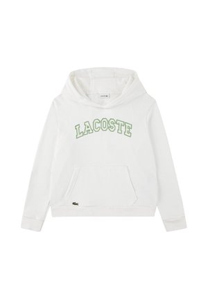 Felpa bianca con cappuccio, tasca frontale e scritta verde "LACOSTE" arcuata sul petto, piccolo logo di coccodrillo verde vicino all'orlo della tasca.