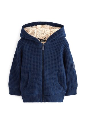 Sweat à capuche zippé en maille bleu marine avec poches avant et doublure polaire beige douce à l’intérieur de la capuche pour la chaleur.