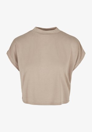 Helebeežist lühikesed varrukad ja kõrge kaelusega lühike t-särk. Valmistatud pehmest kangast, millel on sile tekstuur ja minimalistlik disain.