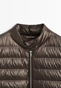 Brown puffer jacket featuring a high collar, horizontal stitching, and a front zipper closure with a rounded snap detail at the collar.