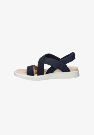 Navy blue sandal with wide crisscross straps, cushioned beige footbed, and white textured rubber sole, side view.