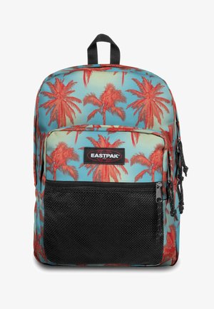 Reppu, jossa on sininen tausta ja suuri punainen palmupuu-kuvio, mustalla verkkotaskulla edessä ja Eastpak-logo. Vetoketjukiinnitykset.
