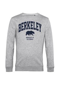 Šedá mikina se jménem "BERKELEY" a "UNIVERSITY OF CALIFORNIA" vytištěnými tmavomodrou barvou, pod textem se nachází silueta medvěda.