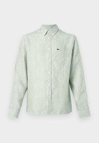 Zöld-fehér csíkos hosszú ujjú ing, gombos kialakítású, mellkasi zsebbel és a bal oldalon egy kis zöld logóval. Pamut anyagból.