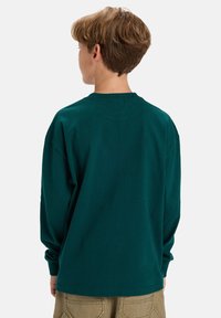Langsleeve, crewneck t-shirt in donker teal, gemaakt van katoen, met een ontspannen pasvorm, doorgestikte schouders en ribgebreide manchetten.