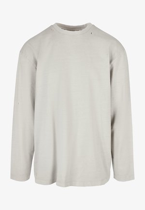 Helles graues Langarmshirt mit Rundhalsausschnitt, das kleine Löcher und einen lässigen Schnitt aufweist. Hergestellt aus weichem, leichtem Baumwollmaterial.