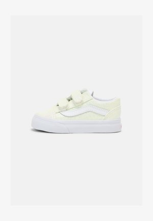 Light green glittery sneakers with dual Velcro straps, white accents, textured rubber sole, and classic Vans side stripe design.