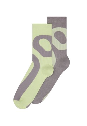 Zelené a sivé ponožky s výrazným abstraktným vzorom, vyrobené z hladkej textúry, s rebrovanými časťami a kontrastnými detailmi.