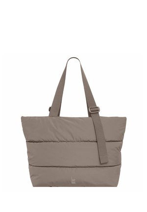 Beige padded tote bag with two wide shoulder straps and horizontal stitching detail. Made from soft, textured fabric. Features brand logo.