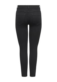 Jeans noirs slim avec poches arrière, passants pour ceinture et taille haute, vus de dos sur un fond blanc.