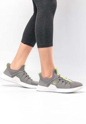 Gray athletic shoes with a textured mesh upper, reflective neon accents, padded collar, and a white rubber sole.