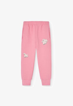 Sweatpants cor-de-rosa feitos de tecido macio, com dois desenhos de cães brancos bordados na parte da frente, com bolsos laterais e pulsos ajustados.