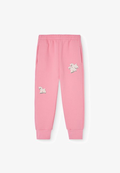 Sweatpants cor-de-rosa feitos de tecido macio, com dois desenhos de cães brancos bordados na parte da frente, com bolsos laterais e pulsos ajustados.