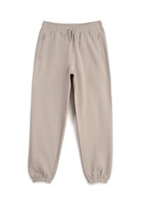 Beżowe spodnie dresowe wykonane z miękkiego materiału, wyposażone w elastyczny pas, regulowany wiązany sznurek i zamykane na zamek boczne kieszenie. Elastyczne mankiety na kostkach.